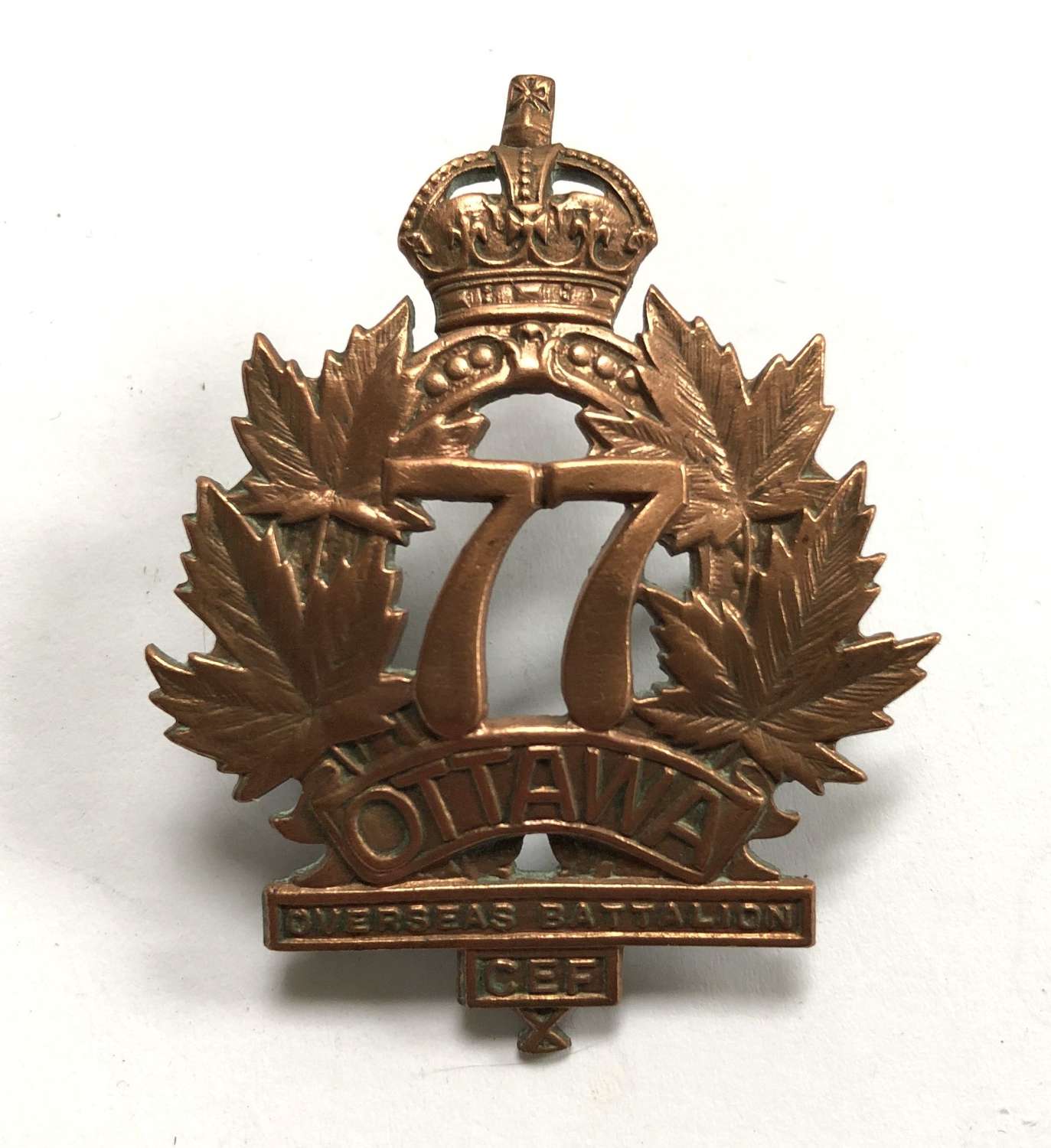 Canadian 77th Bn. CEF cap badge by Ingliss
